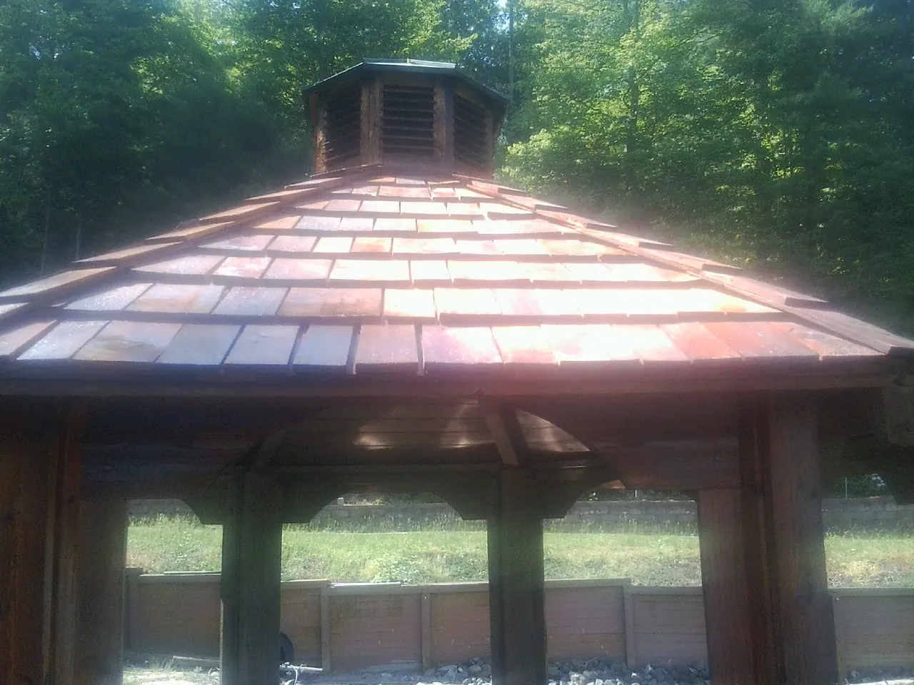 New cedar shake roof and cupola on a lakeside gazebo in Montville